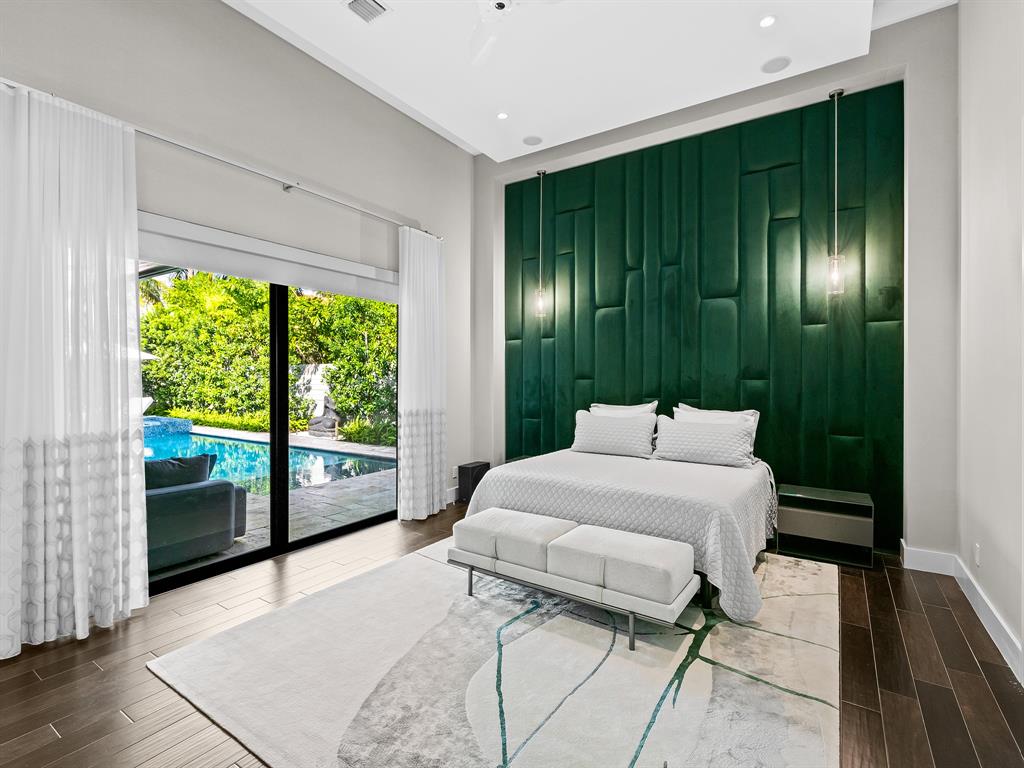 1710 Middle River Drive Fort Lauderdale, FL 33305 - Photo 27 of 47 a bedroom with a bed and a large window