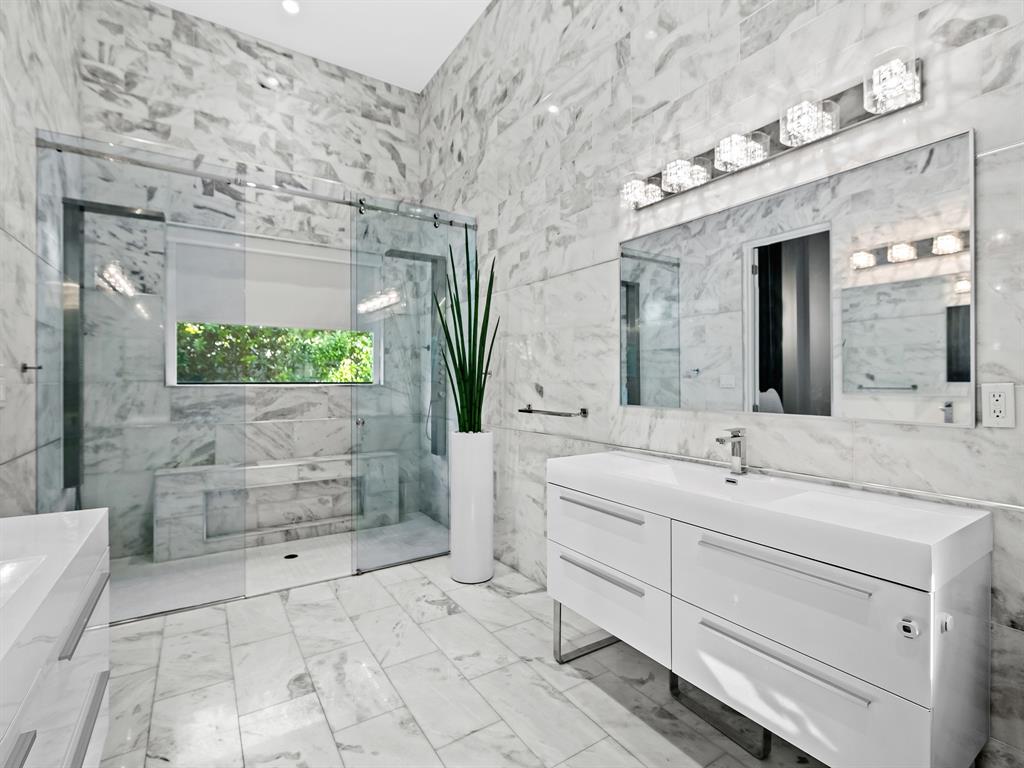 1710 Middle River Drive Fort Lauderdale, FL 33305 - Photo 30 of 47 a spacious bathroom with a granite countertop sink a mirror and a shower