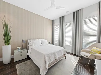 a bedroom with a bed and a potted plant