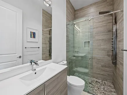 a bathroom with a sink toilet and shower