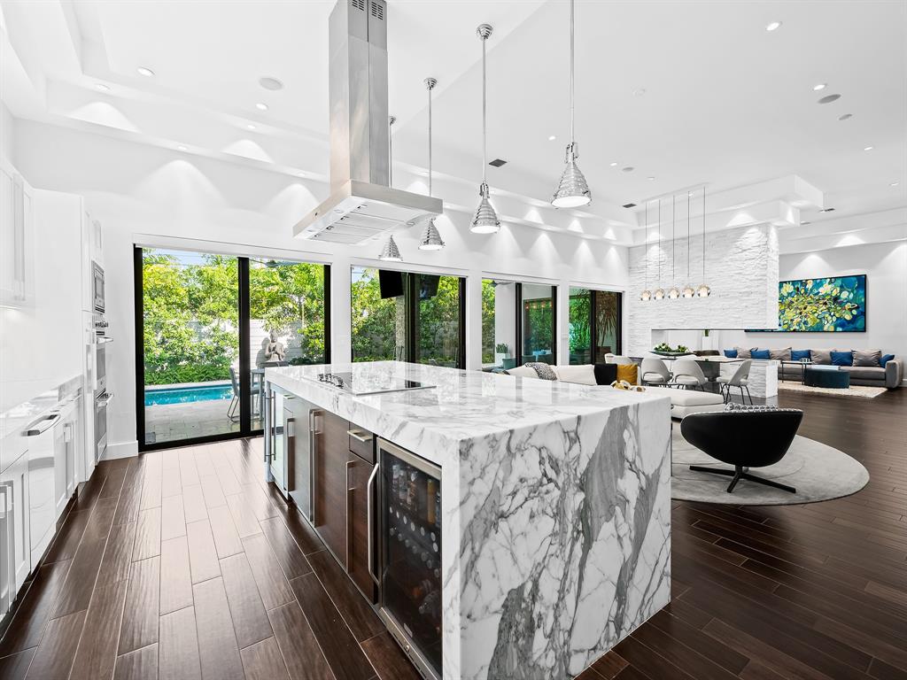 1710 Middle River Drive Fort Lauderdale, FL 33305 - Photo 4 of 47 a open kitchen with stainless steel appliances granite countertop a stove and a large window with garden view