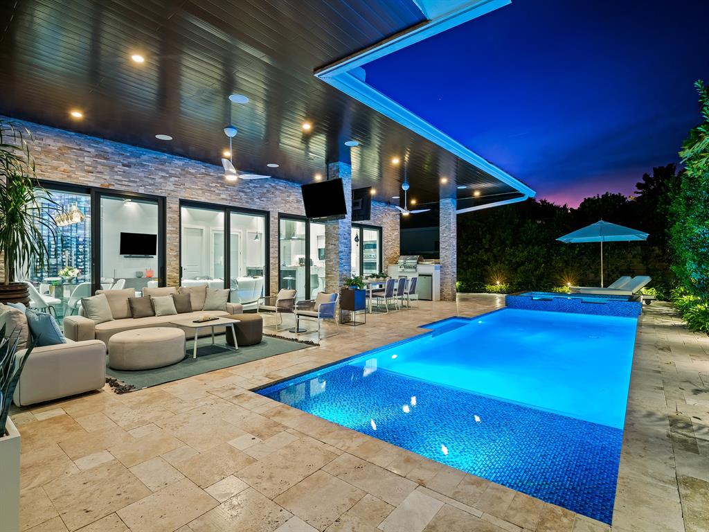 1710 Middle River Drive Fort Lauderdale, FL 33305 - Photo 44 of 47 a view of an outdoor dining space with swimming pool and furniture