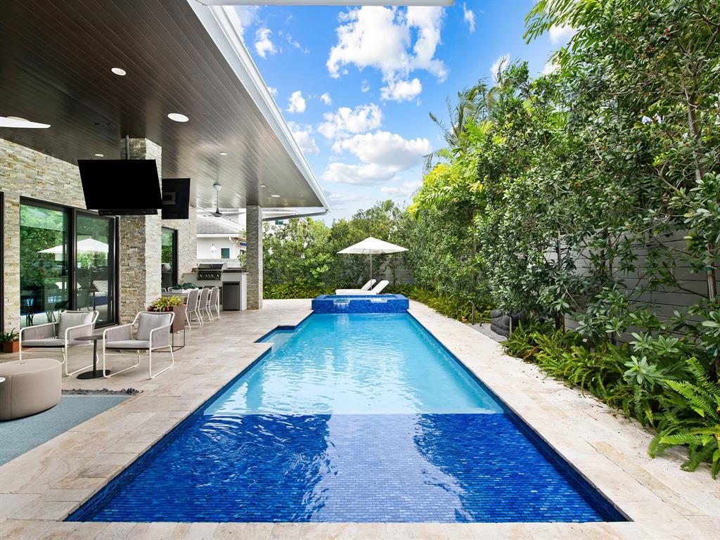 1710 Middle River Drive Fort Lauderdale, FL 33305 - Photo 8 of 47 a view of a living room and kitchen with furniture