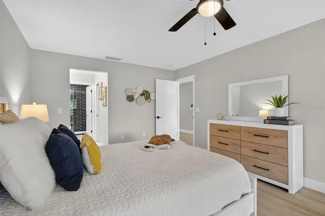 a bedroom with a bed and wooden floor