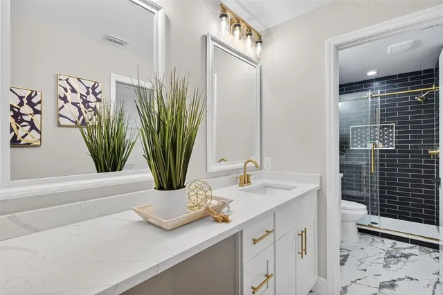 a bathroom with a sink a mirror and vanity