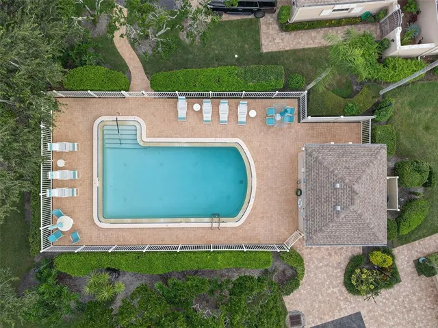 an aerial view of a house with garden space and street view
