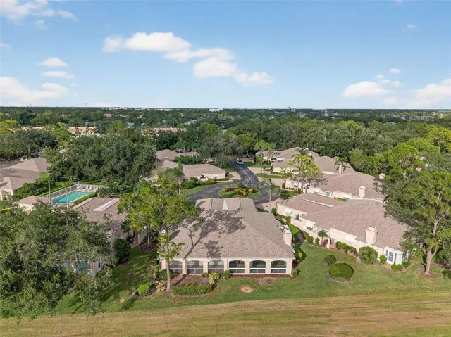 an aerial view of residential houses with outdoor space