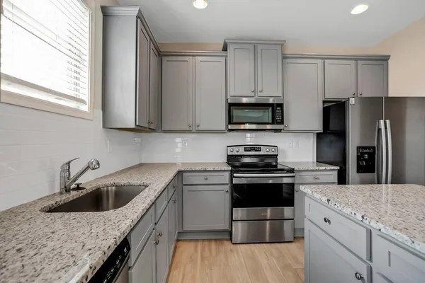 a kitchen with a sink stove and refrigerator