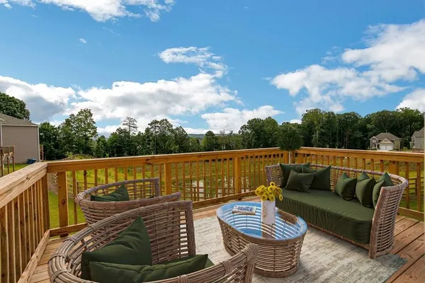 a roof deck with couches and potted plants