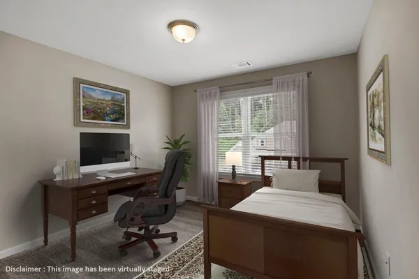 a view of a workspace with furniture and a window