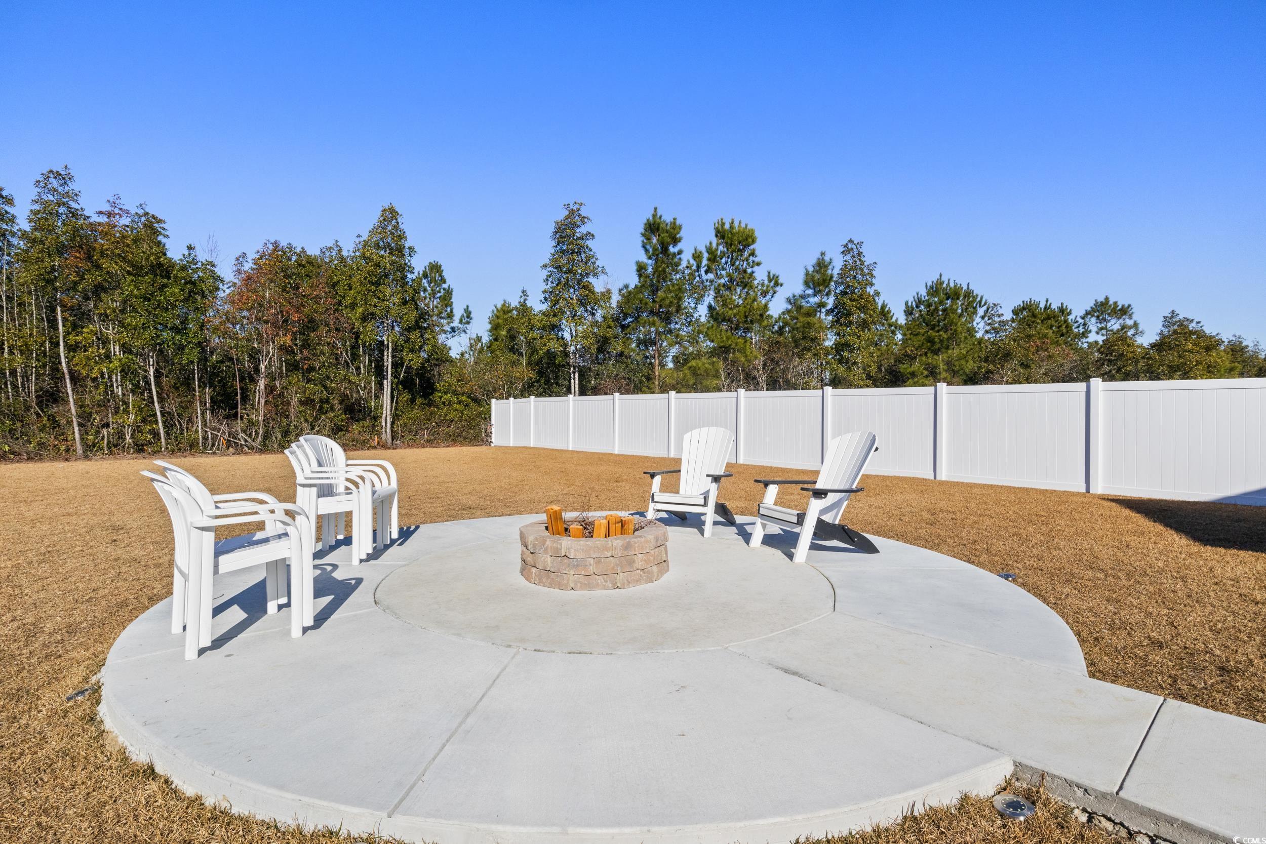 724 Enchantment Loop Myrtle Beach, SC 29588 - Photo 28 of 39 View of patio featuring a fire pit
