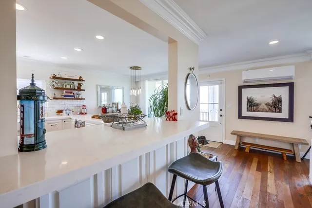 a dining room with furniture a chandelier and wooden floor