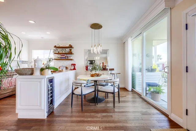 a kitchen with a dining table chairs refrigerator and cabinets