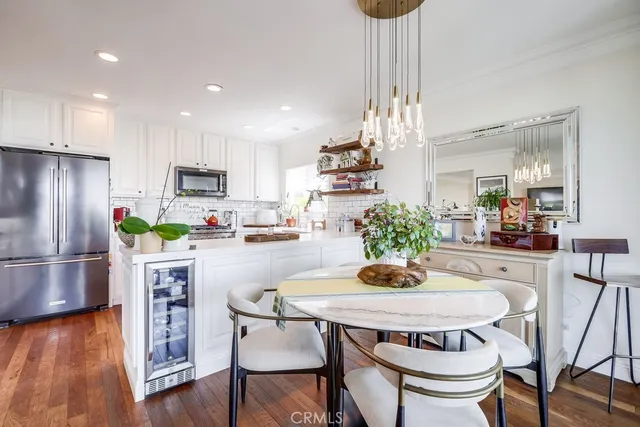 a kitchen with stainless steel appliances a sink cabinets and a window