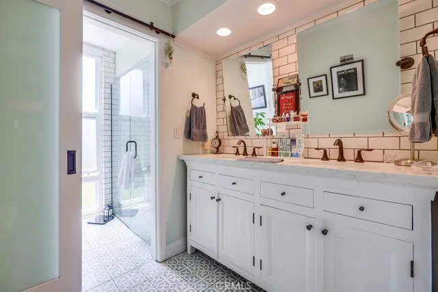a spacious bathroom with a sink and a mirror