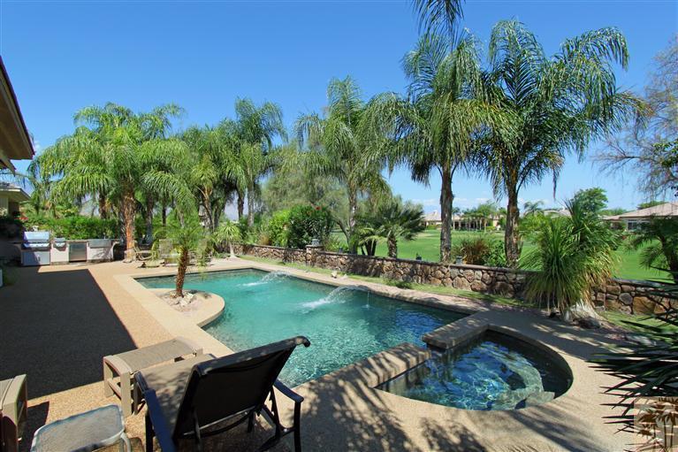 a view of a swimming pool and lounge chairs