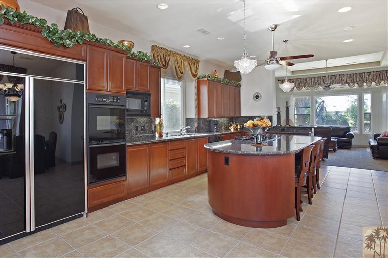 59 Calle Del Norte Rancho Mirage, CA 92270 - Photo 11 of 25 a large kitchen with stainless steel appliances kitchen island granite countertop a refrigerator a oven and a sink