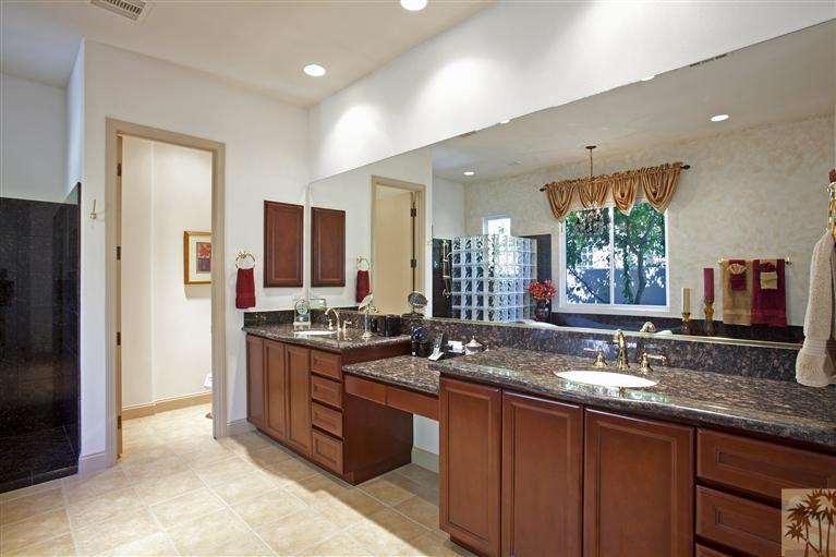 59 Calle Del Norte Rancho Mirage, CA 92270 - Photo 15 of 25 a bathroom with a granite countertop sink and a mirror