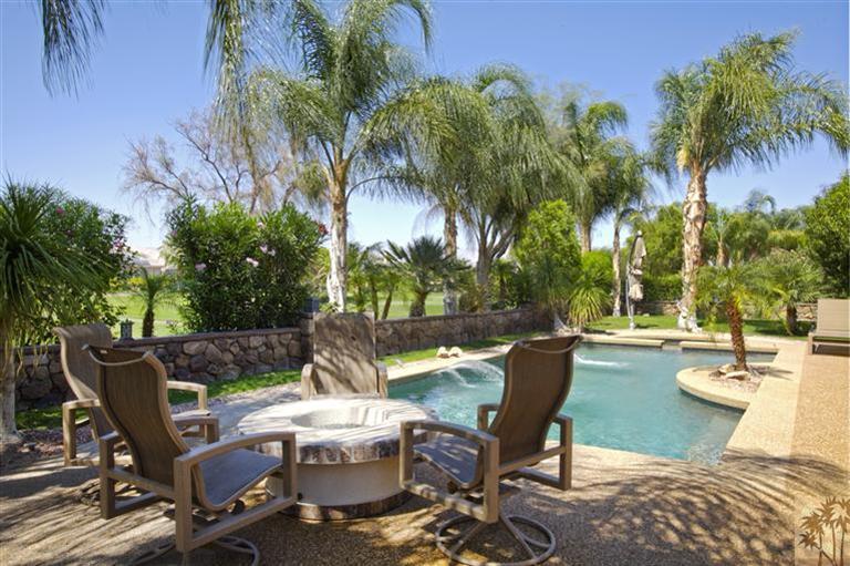 59 Calle Del Norte Rancho Mirage, CA 92270 - Photo 25 of 25 a view of a patio with table and chairs potted plants and palm tree