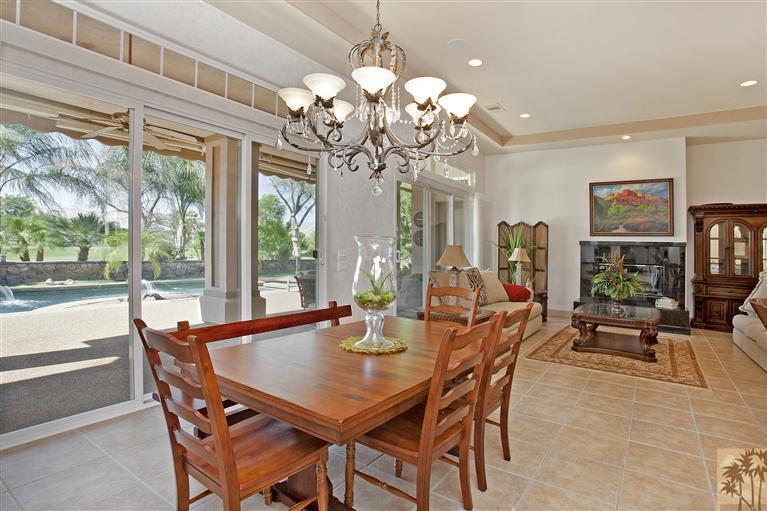 59 Calle Del Norte Rancho Mirage, CA 92270 - Photo 7 of 25 a view of a dining room with furniture a chandelier and large windows