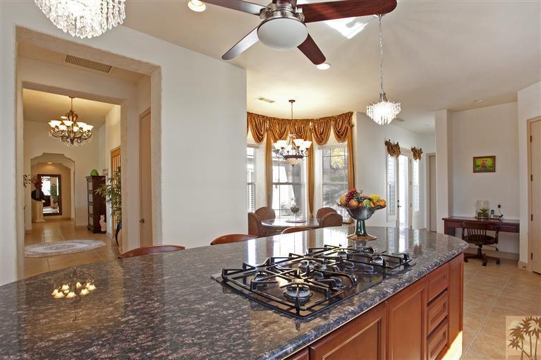 59 Calle Del Norte Rancho Mirage, CA 92270 - Photo 10 of 25 a kitchen with a stove a sink and a chandelier