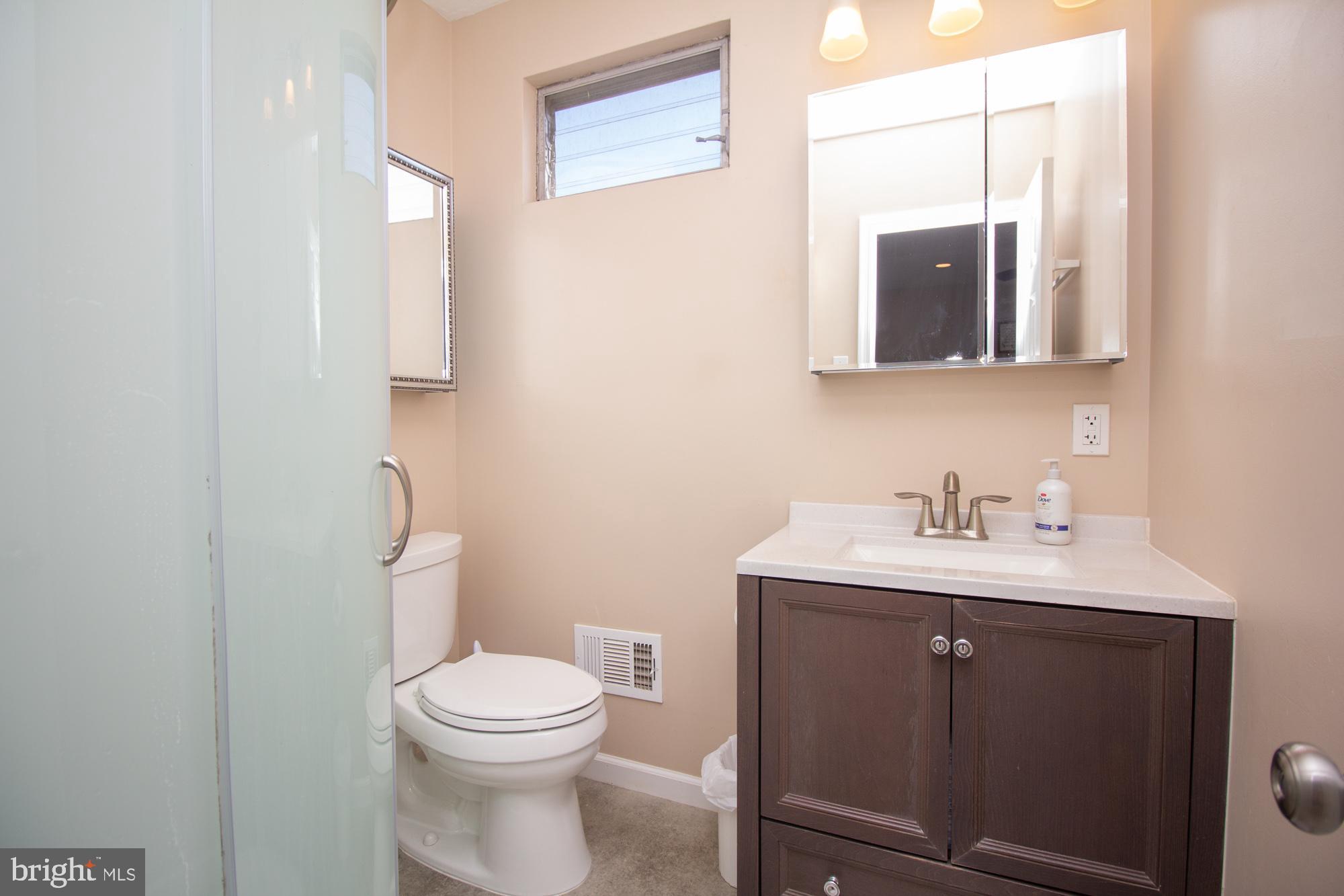 518 Ehret Road Fairless Hills, PA 19030 - Photo 21 of 37 a bathroom with a toilet a sink and mirror