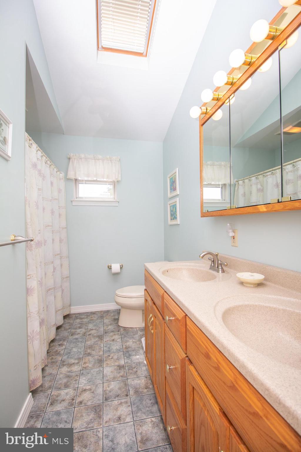 518 Ehret Road Fairless Hills, PA 19030 - Photo 26 of 37 a spacious bathroom with a sink a toilet a mirror and shower