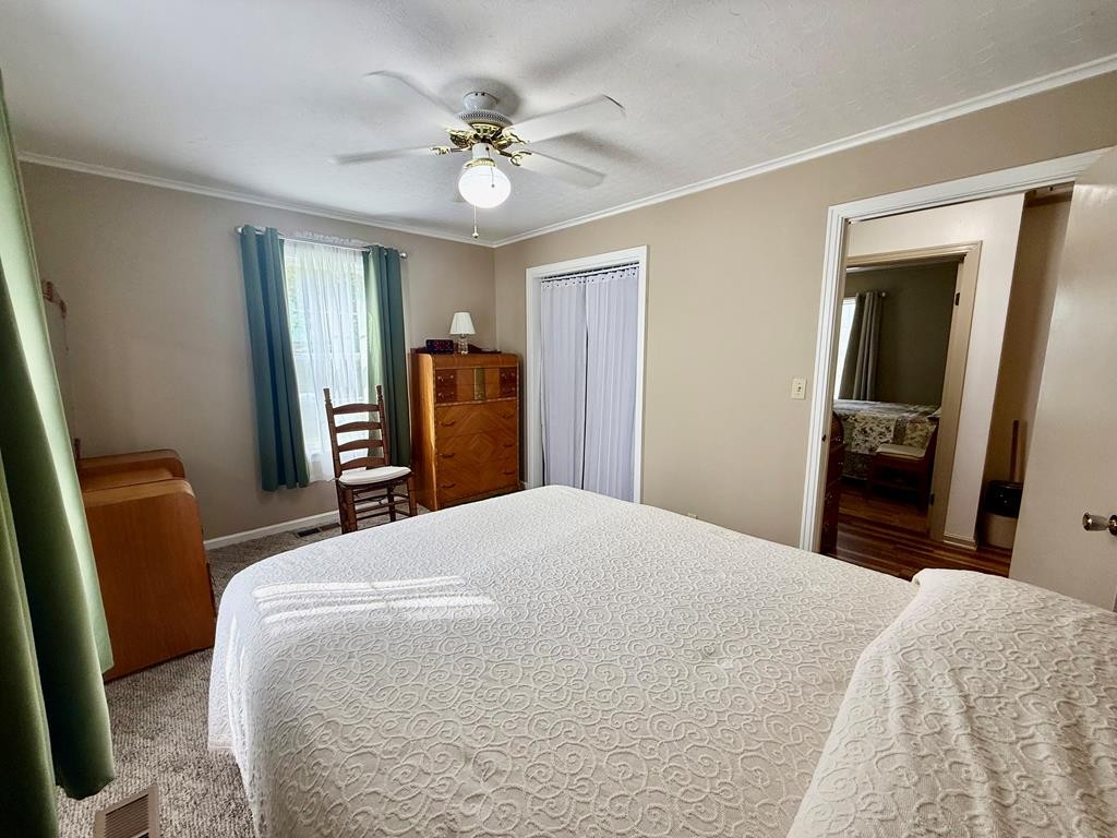180 Center Drive Springville, TN 38256 - Photo 13 of 30 a bedroom with a bed and wooden floor