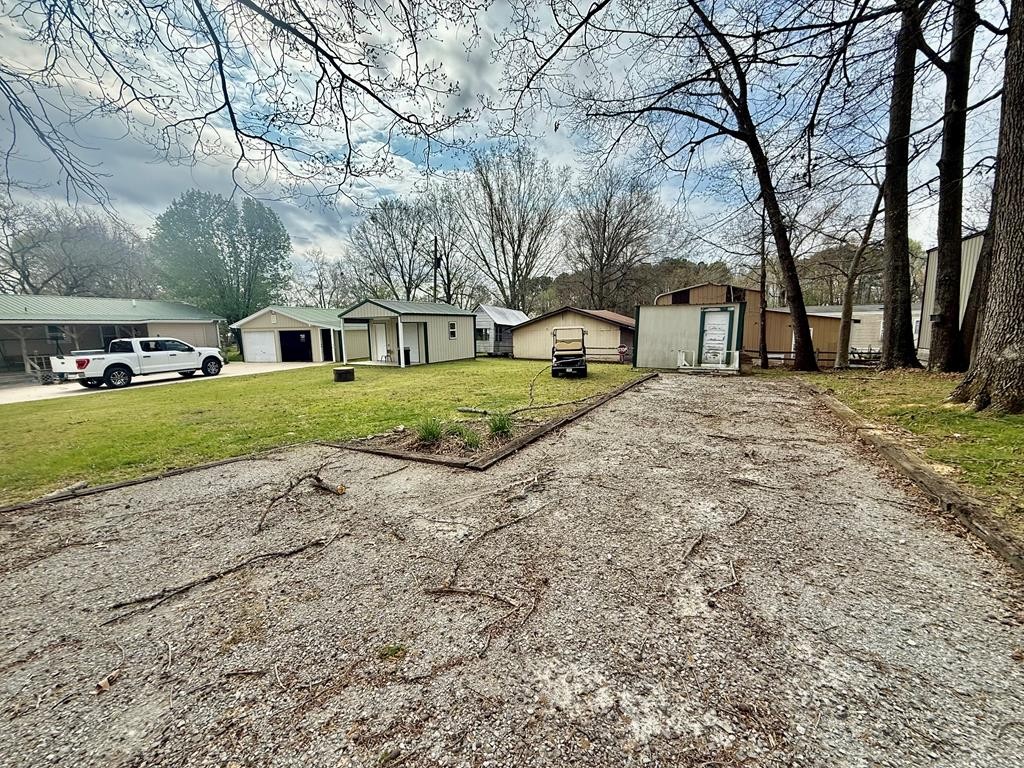 180 Center Drive Springville, TN 38256 - Photo 20 of 30 a view of a yard with a house and trees