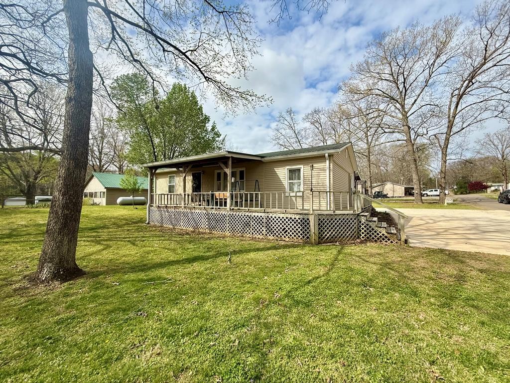 180 Center Drive Springville, TN 38256 - Photo 23 of 30 a view of a house with a big yard and large trees