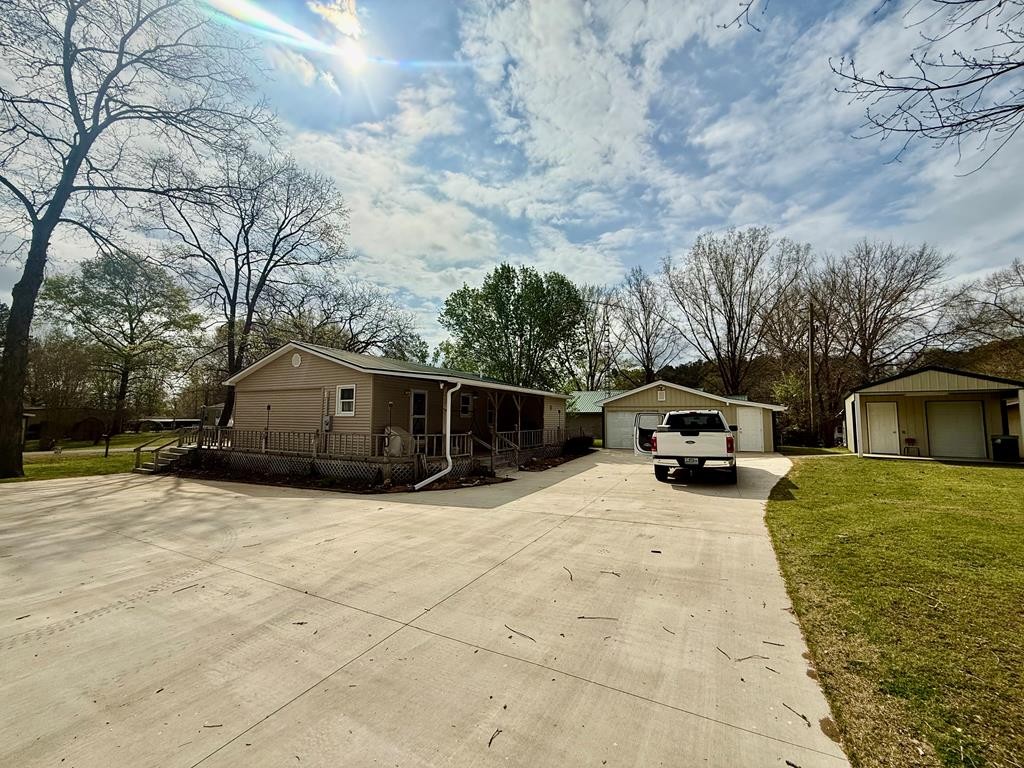 180 Center Drive Springville, TN 38256 - Photo 30 of 30 a view of a house with a yard covered with snow in it