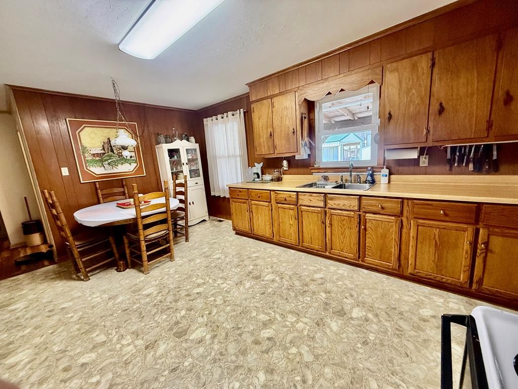 180 Center Drive Springville, TN 38256 - Photo 6 of 30 a large kitchen with cabinets chairs and wooden floor