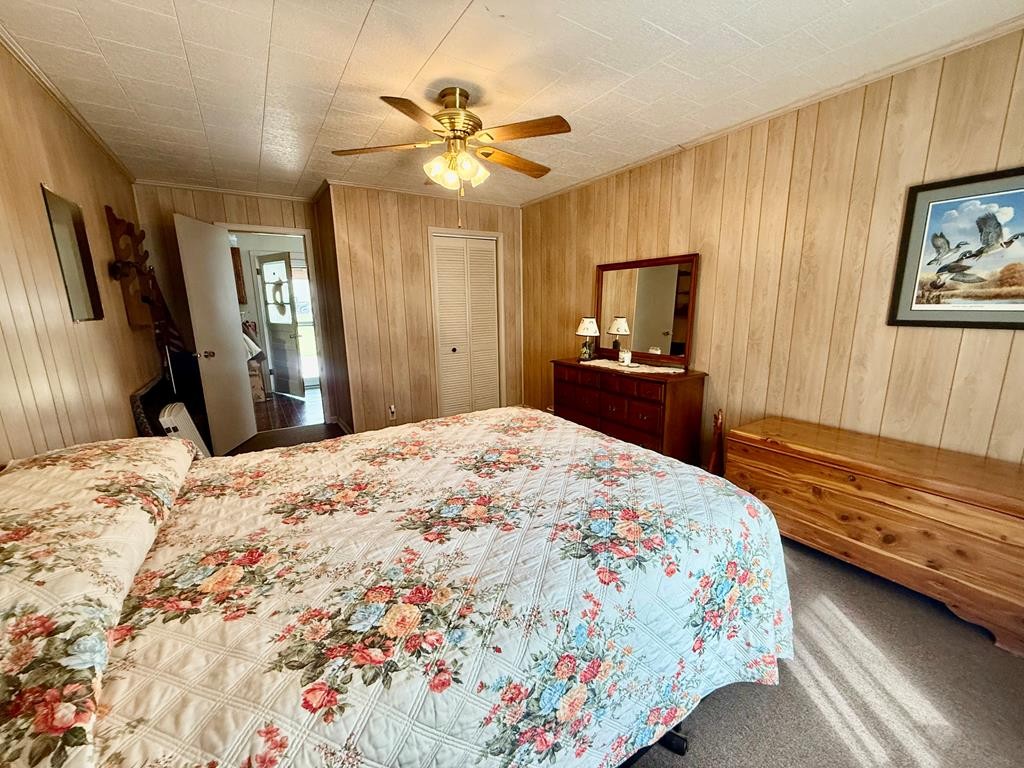 180 Center Drive Springville, TN 38256 - Photo 8 of 30 a bedroom with a bed and a chandelier