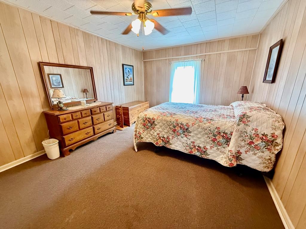 180 Center Drive Springville, TN 38256 - Photo 9 of 30 a bed sitting in a bedroom next to a window