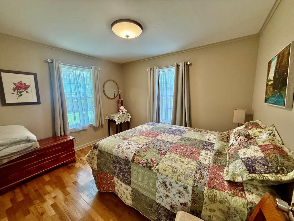 180 Center Drive Springville, TN 38256 - Photo 10 of 30 a bedroom with a bed and wooden floor