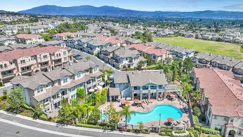 an aerial view of residential building and lake