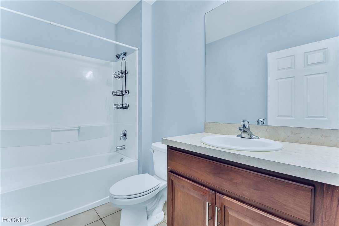 10357 Silver Pond Lane Lehigh Acres, FL 33936 - Photo 14 of 25 a bathroom with a sink a toilet and shower