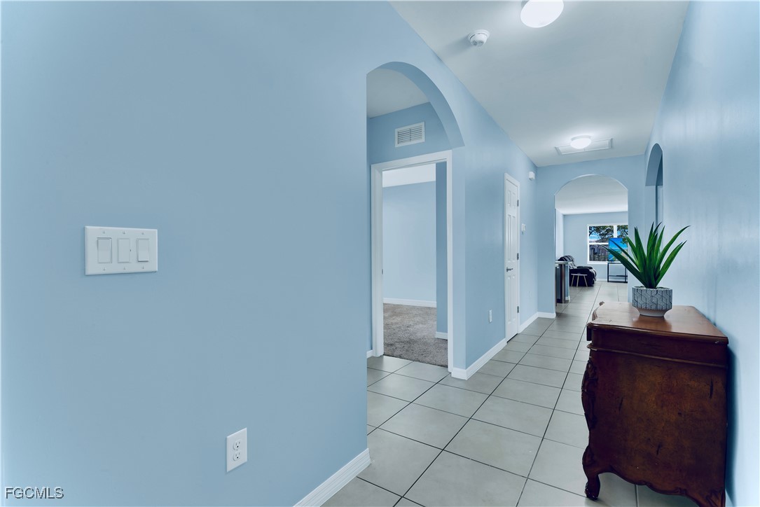 10357 Silver Pond Lane Lehigh Acres, FL 33936 - Photo 2 of 25 a view of a hallway with a potted plant