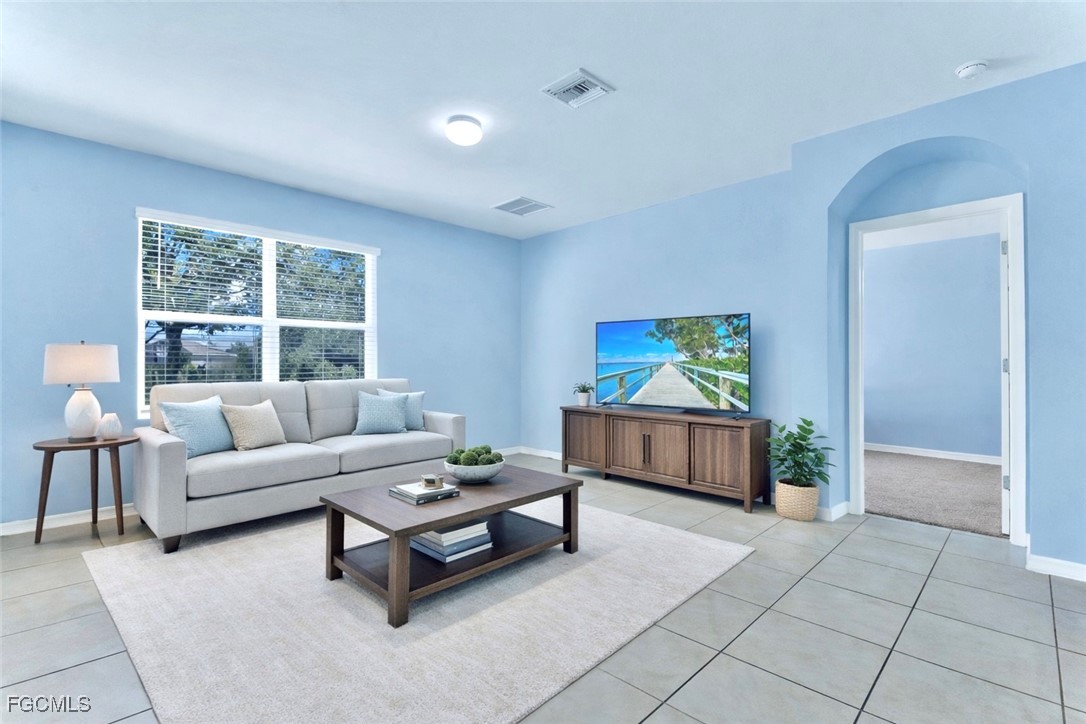 10357 Silver Pond Lane Lehigh Acres, FL 33936 - Photo 4 of 25 a living room with furniture and a window