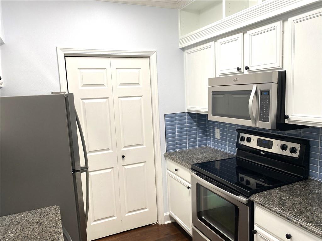 3777 Peachtree Road Northeast, Unit 1517 Atlanta, GA 30319 - Photo 12 of 37 a kitchen with granite countertop a refrigerator stove and microwave