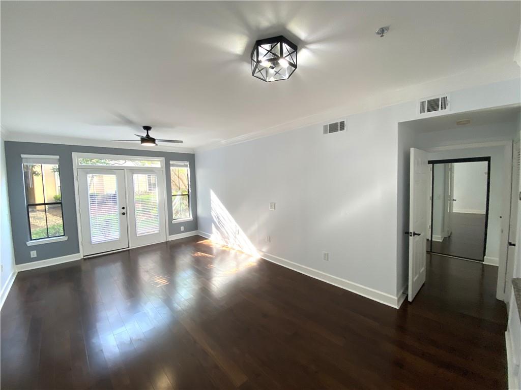 3777 Peachtree Road Northeast, Unit 1517 Atlanta, GA 30319 - Photo 15 of 37 a view of an empty room with wooden floor and a window
