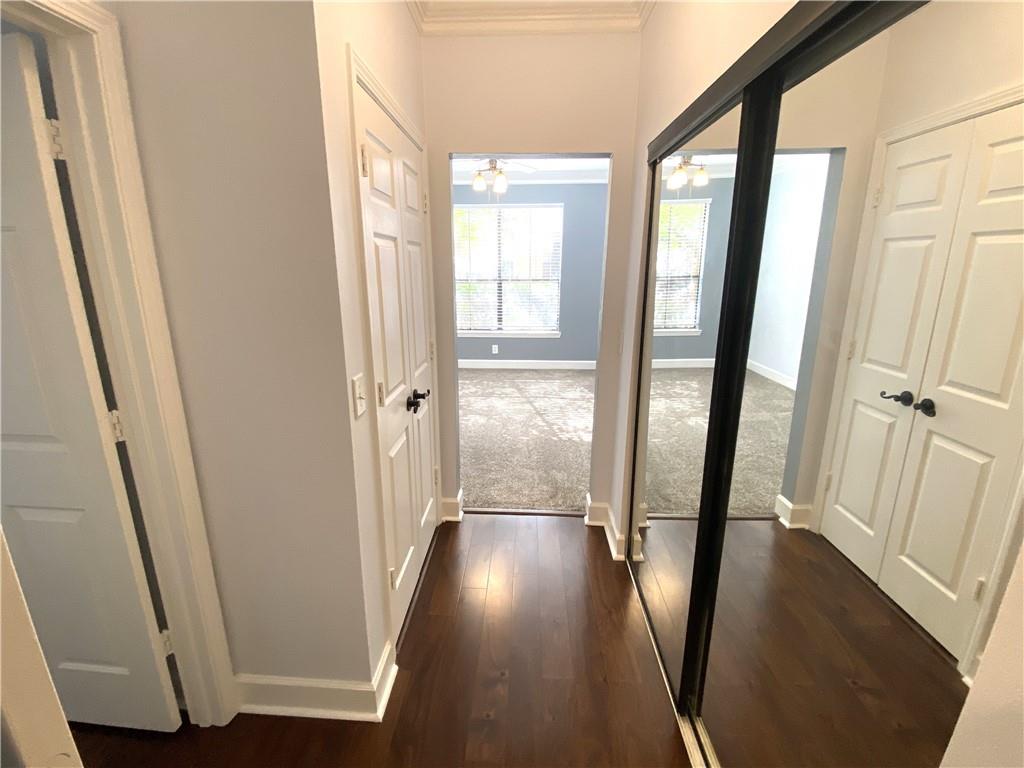3777 Peachtree Road Northeast, Unit 1517 Atlanta, GA 30319 - Photo 19 of 37 a view of a hallway with wooden floor and staircase