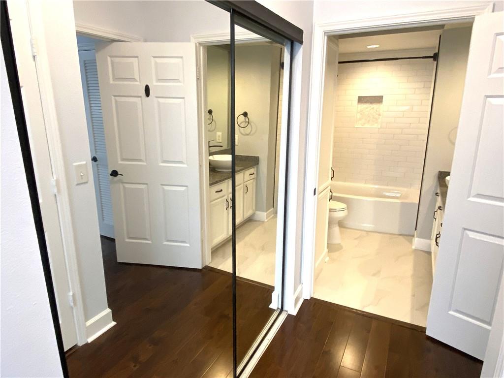 3777 Peachtree Road Northeast, Unit 1517 Atlanta, GA 30319 - Photo 24 of 37 a view of a bathroom with a glass door shower and a sink