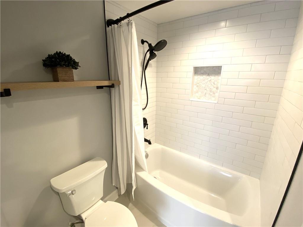3777 Peachtree Road Northeast, Unit 1517 Atlanta, GA 30319 - Photo 26 of 37 a bathroom with a toilet and a shower