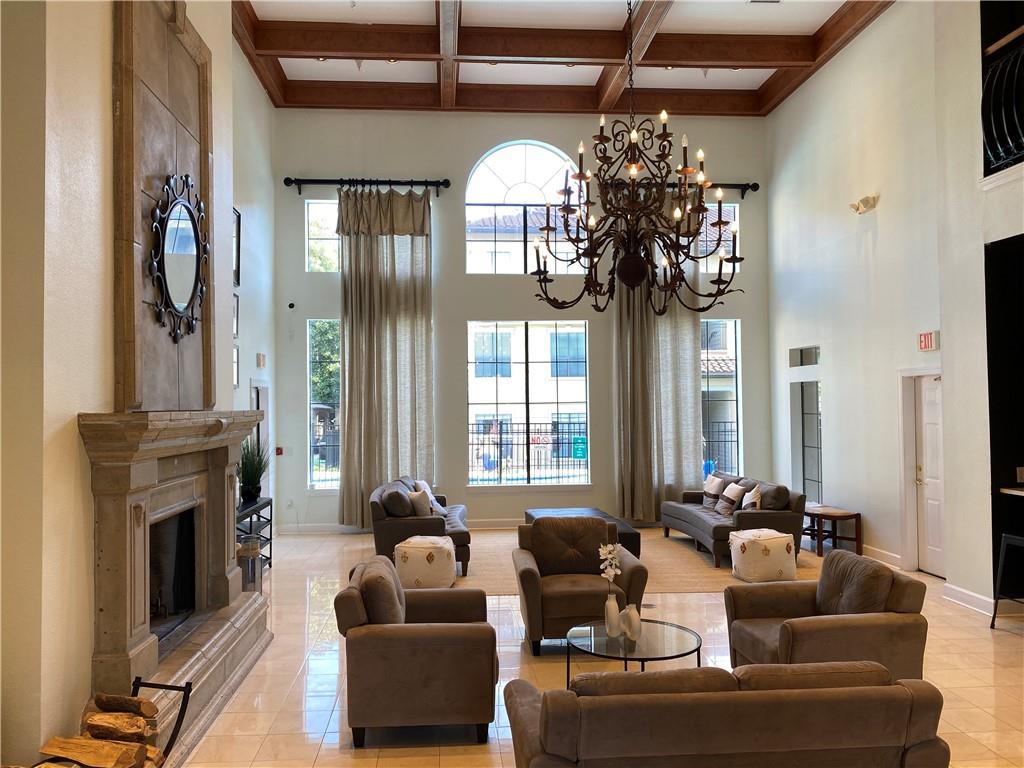 3777 Peachtree Road Northeast, Unit 1517 Atlanta, GA 30319 - Photo 34 of 37 a living room with fireplace furniture and a chandelier