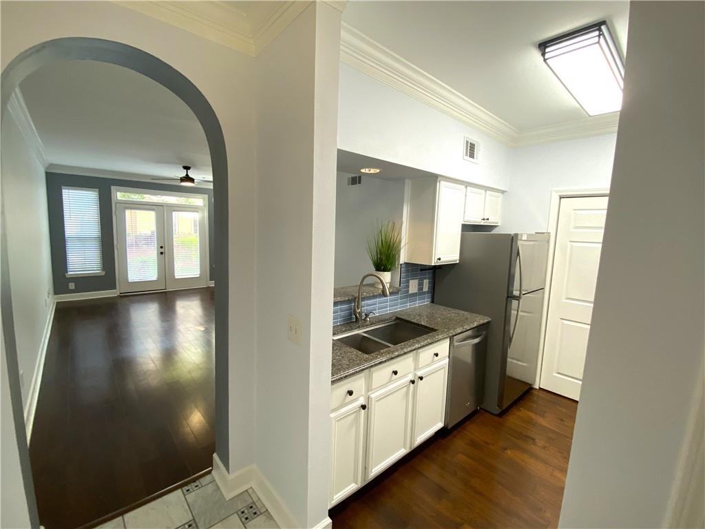 3777 Peachtree Road Northeast, Unit 1517 Atlanta, GA 30319 - Photo 4 of 37 a kitchen with stainless steel appliances granite countertop a refrigerator a stove and a wooden floors