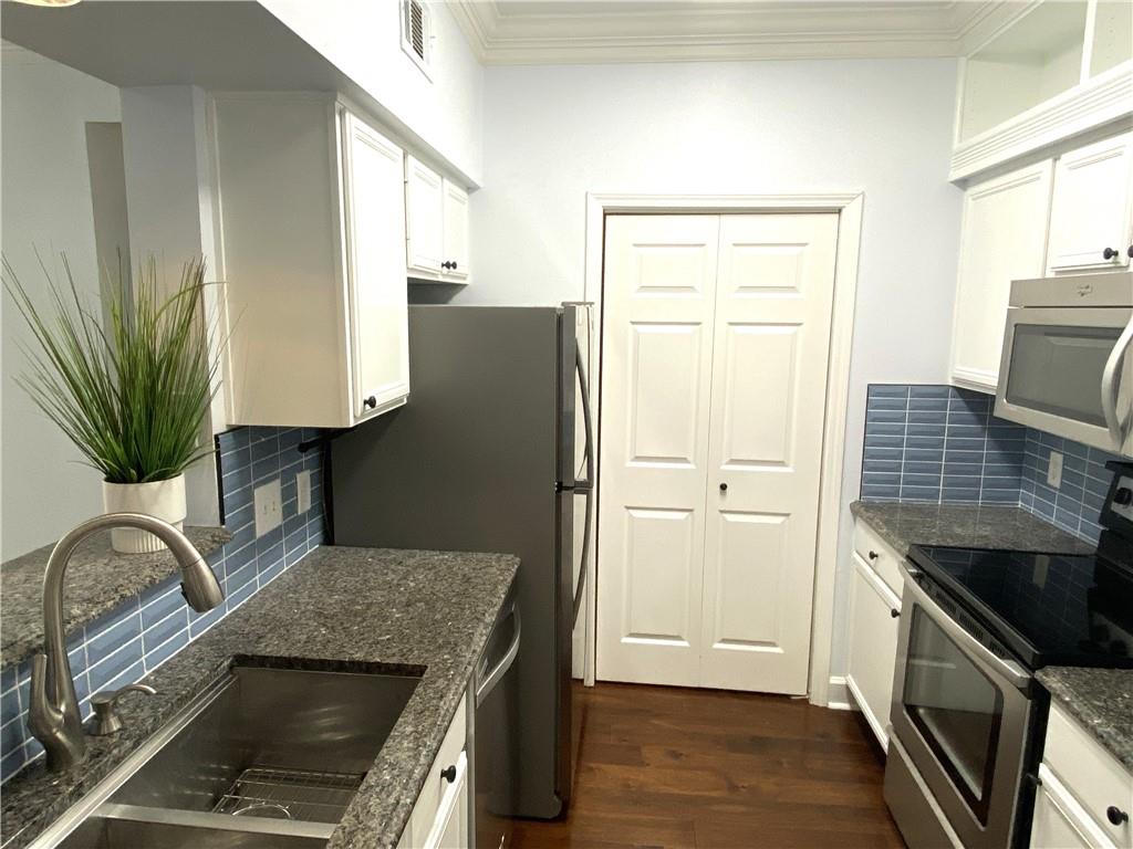 3777 Peachtree Road Northeast, Unit 1517 Atlanta, GA 30319 - Photo 5 of 37 a kitchen with a refrigerator and a sink