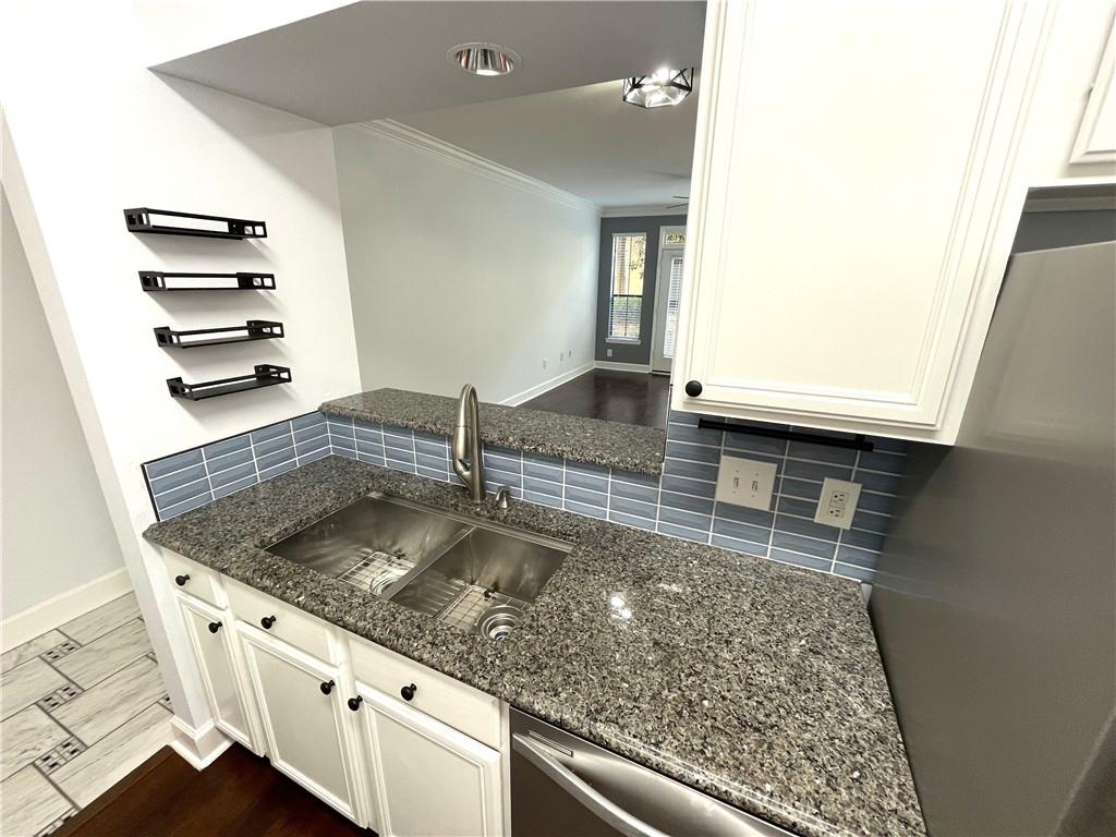3777 Peachtree Road Northeast, Unit 1517 Atlanta, GA 30319 - Photo 6 of 37 a kitchen with granite countertop a sink and a stove