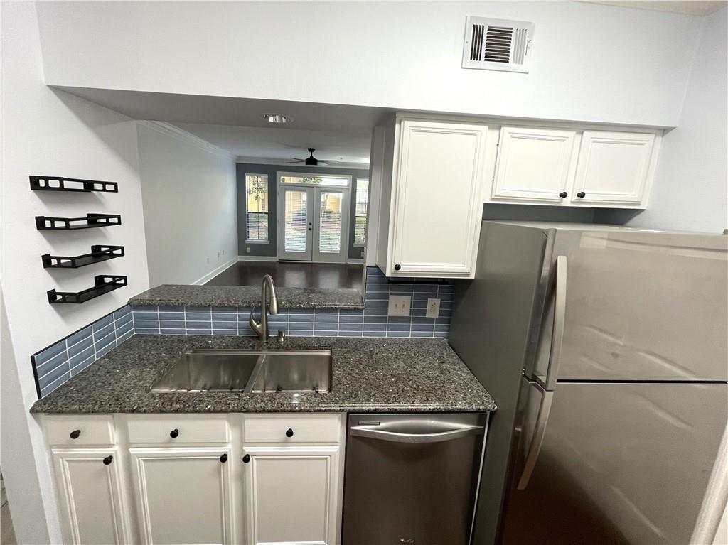 3777 Peachtree Road Northeast, Unit 1517 Atlanta, GA 30319 - Photo 8 of 37 a kitchen with stainless steel appliances granite countertop a sink a refrigerator and a granite counter tops