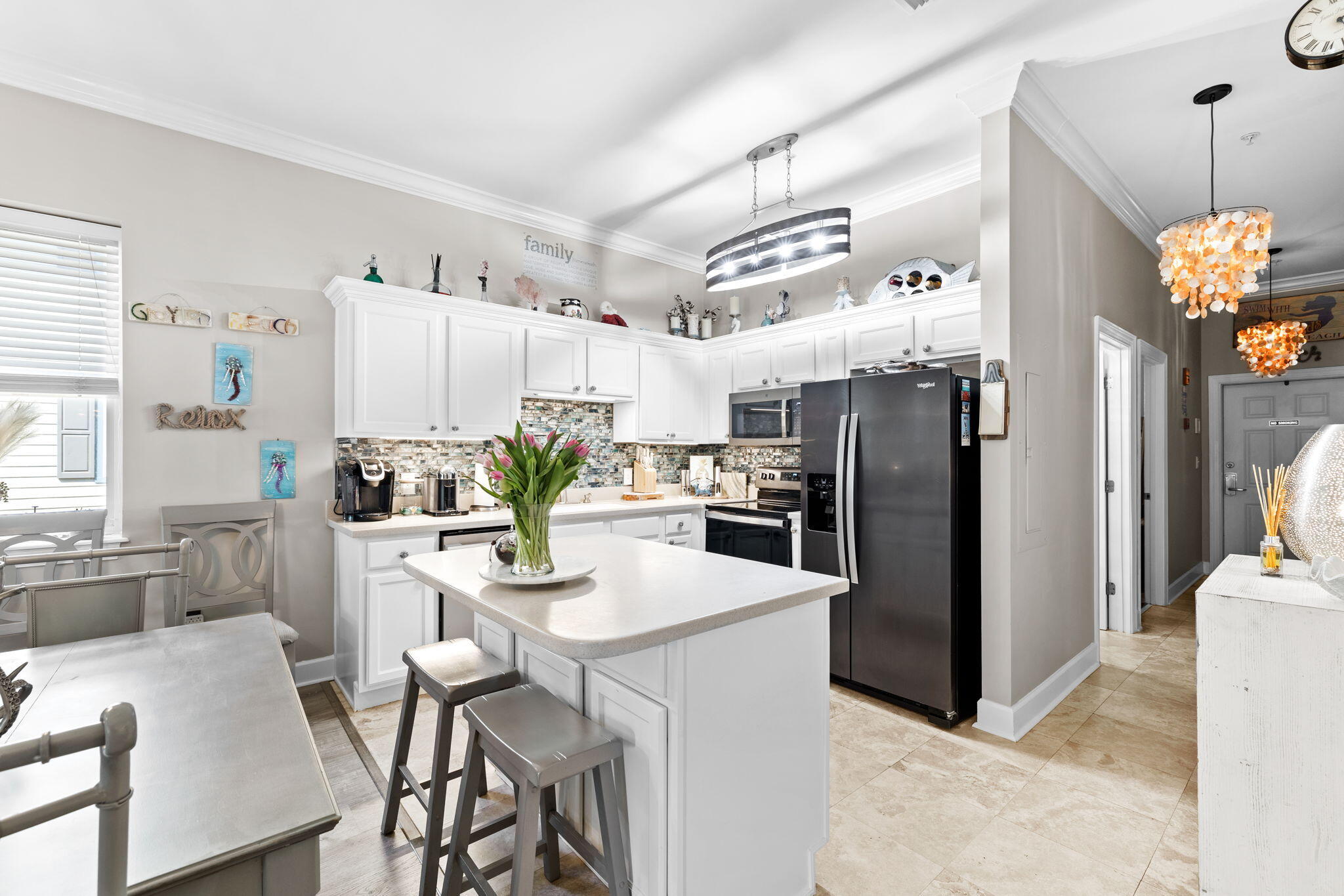231 Somerset Bridge Road, Unit 1301 Santa Rosa Beach, FL 32459 - Photo 7 of 26 a kitchen with stainless steel appliances kitchen island granite countertop a refrigerator a stove a sink dishwasher and white cabinets with wooden floor
